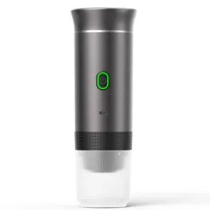 Portable BrewMaster Trio espresso machine in sleek grey design, showcasing its compact size and versatile features. The device is held in a hand, emphasizing its portability. The image displays the machine's 3-in-1 compatibility with ground coffee and capsules, USB-C charging port, and intuitive single-button interface. The stainless steel water tank with volume markings is visible, highlighting the product's premium build quality and attention to detail. In the background, a steaming cup of freshly brewed espresso with rich crema suggests the high-quality coffee experience the BrewMaster Trio delivers, whether at home, in the office, or on outdoor adventures.