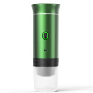 Portable BrewMaster Trio espresso machine in sleek green design, showcasing its compact size and versatile features. The device is held in a hand, emphasizing its portability. The image displays the machine's 3-in-1 compatibility with ground coffee and capsules, USB-C charging port, and intuitive single-button interface. The stainless steel water tank with volume markings is visible, highlighting the product's premium build quality and attention to detail. In the background, a steaming cup of freshly brewed espresso with rich crema suggests the high-quality coffee experience the BrewMaster Trio delivers, whether at home, in the office, or on outdoor adventures.